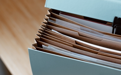 A portable filing briefcase with papers inside.
