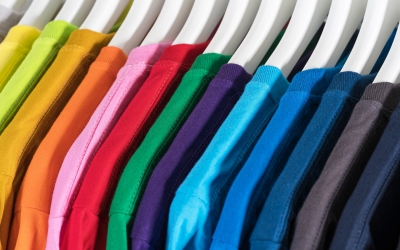 An extreme close up of colorful hanging clothes.